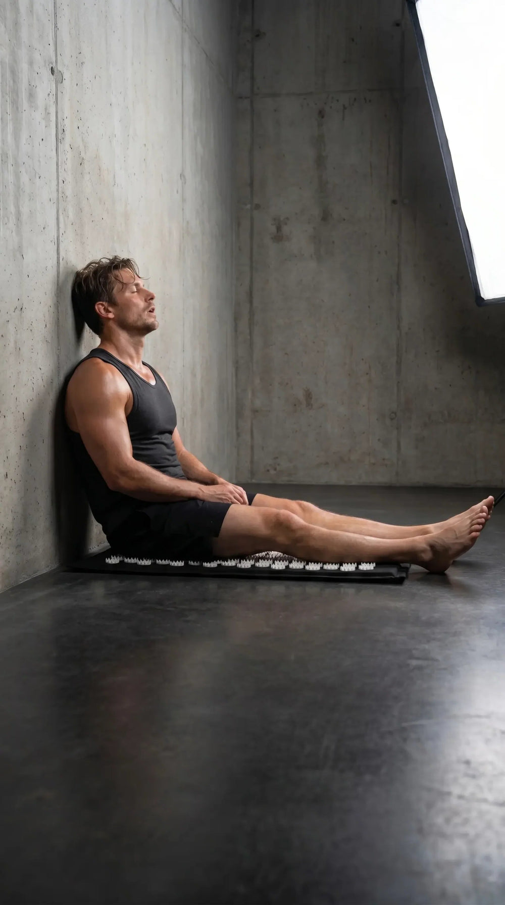 Athlete recovering on the acupressure mat after training